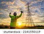 Engineer succeeded after checking at the power station for planning work by generating electricity from the high-voltage transmission tower at sunset.