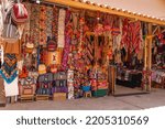 Small photo of Souvenirs at the Pisac artisan market, Cusco, Peru. Sale of souvenirs (ponchos, backpacks, clothes, blankets...). Colorful ethnic market.