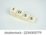 Small photo of Loss and economic downfall concept, losing money, loss text on white blocks, rising prices and tax idea, crisis and collapse, bad economy, decreasing money value