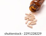 Small photo of View From Above Capsules OF Slippery Elm, Brown Glass Bottle On White Background. Herbal Supplement, Medication. Ulmus Fulva, Natural Remedy Concept. Horizontal, Top View, Copy Space.