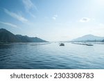 Small photo of View of the calm Seto Inland Sea from the ferry to Miyajima in Hiroshima, Japan