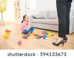 Small photo of gloat little asian kid mess up all over of living room sitting on wooden floor and hard working business mother back from work feel shocked and angry.