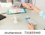 Small photo of close up of travel agent company office worker with traveler customer handshake when they finished deal. selective focus photo.