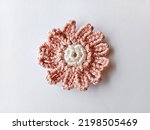 Small photo of Crochet flower. Crochet of daisy flower. Crocheted flower on white background.