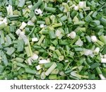 Green onion. Chopped fresh green onions. Spring onions. Spring chopped onions. Chopped green onions background. Top view.