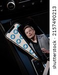 Small photo of MADURAI, INDIA - MAY 18, 2022: Lot of logos of social network Twitter on smartphone screen and Elon Musk photo on another smartphone screen background.