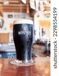Small photo of Cork, Ireland - 2010: Pint glass of Murphy's stout beer served in pub