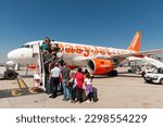 Small photo of Madrid, Spain - July 11, 2012: Passengers boarding Easyjet plane