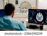 Small photo of A girl lies on an MRI machine before examining her body and the radiologist gives command to her to prepare for a diagnosis