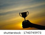 silhouette hand holding trophy... | Shutterstock . vector #1740745973