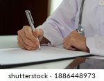 hand doctor holding a pen write ... | Shutterstock . vector #1886448973