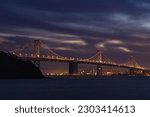 A picture of the Oakland Bay Bridge as seen from Treasure Island at night.