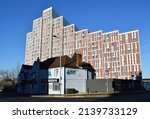 Small photo of Bracknell, Berkshire, UK- Jan 14, 2022: A soulless, monolithic and imposing high-rise serviced apartment building sits behind a tasteful and human-scaled traditional pub.