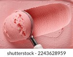 pink strawberry ice cream ball in a spoon, top view