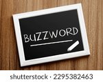 ?halkboard with text BUZZWORD on wooden background