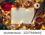 Blank paper Christmas letter to or from Santa surrounded by Christmas decorations with hot chocolate