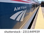 Small photo of New Haven, Connecticut - May 18 2023: Amtrak logo on the side of a train stopped at a station in connecticut. Vermonter trains switch engines from electric to diesel at the New Haven stop.
