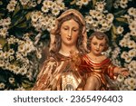 Small photo of Image of Our Lady of Mount Carmel on the solemnity of July 16th on a scaffold with flowers