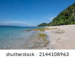 Small photo of low tide midday on Puka shells beach with lush forest, mountains, coconut trees, and Fishermen’s .In Boracay Island, August 19 2021.