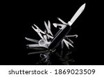 Small photo of multipurpose pocket knife on black background