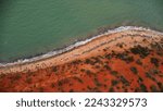 Small photo of Monkey Mia, where the desert meets the sea and untouched vibrant red sand and blue ocean in Francois Peron National Park, Western Australia