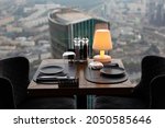 Dinner at sunset with panoramic views of the Moscow business center. Dinner on the background of the city. Restaurant overlooking downtown. Romantic setting, Moscow, Russia