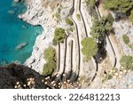 Via Krupp, Capri island, Italy, the famous hairpin turn road on a steep rocky cliff over blue Mediterranean sea in the Bay of Naples