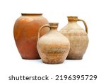 Antique ceramic decorative amphora on a white background. Clay jugs and a pot, a set of ancient utensils for drinking wine, water or milk.