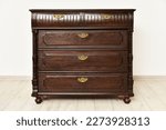 Small photo of Old chest of drawers cupboard inside a room with light walls. Home interior vintage retro furniture bedchamber
