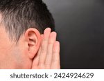 Small photo of Man is listening intently with holds his hand to his ear. Concept of wiretapping, gossip gathering, eavesdropping. Like What you say copy space?