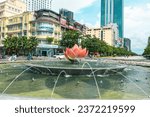 Small photo of Ho Chi Minh City, Vietnam - October 07, 2023: A lotus-shaped fountain on Nguyen Hue street walking in front of Ho Chi Minh statue and Ho Chi Minh People's Committee, Saigon, Ho Chi Minh City, Vietnam