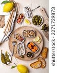 Small photo of Tinned fish charcuterie board. Seacuterie appetizers platter with canned fish and seafood. Food trend for party and tinned fish date night