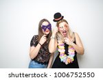 two young girls pose photo booth props happy funny white background smile models 