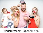 young family at white background photo booth with party props happy funny smile strike pose celebration wedding anniversary 