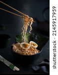 Small photo of Hot Noodle Curry Asian Hong Kong Japanese Ramen Soup Hot Food South Asian Egg Mushroom Chopsticks SeaWeed Bouillon Cabbage Steamy Food Dark Mood