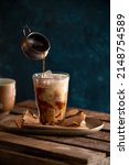 Small photo of Ice Coffee Cold Levitation Flying Cup Glass Rustic Wooden Dark Industrial Moody Morning Icetea Fresh Pouring Spilled Drop Plate Brown Blue Action Mug Milk Levitating Espresso Mix Black Pour Cappuccino