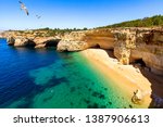 Corredoura Beach, sighted viewpoint on the trail of the Seven Suspended Valleys (Sete Vales Suspensos). Praia da Corredoura with flying seagulls near Benagil village, Algarve, Portugal.