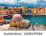 Mosque in the old Venetian harbor of Chania town on Crete island, Greece. Old mosque in Chania. Janissaries or Kioutsouk Hassan Mosque in Chania Crete. Turkish mosque in Chania bay. Crete, Greece.