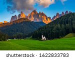 Landscapes with San Giovanni Church and small village in Val di Funes, Dolomite Alps, South Tyrol, Italy, Europe. San Giovanni in Ranui church (St John in Ranui church) in the Dolomites, Italy.