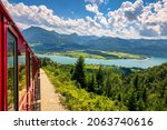Schafbergbahn mountain train, Schafberg mountain, Salzkammergut region, Salzburg Land state, Austria. Journey to the top of Alps through lush fields and green forests.View of lake Wolfgangsee.