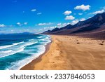 Small photo of Amazing Cofete beach with endless horizon. Volcanic hills in the background and Atlantic Ocean. Cofete beach, Fuerteventura, Canary Islands, Spain. Playa de Cofete, Fuerteventura, Canary Islands.
