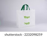 Small photo of fabric eco bags empty or cotton thread fabric bags, empty bags and green recycling symbol isolated on white, fabric fabric eco bag green blank template, for campaign to use bags to reduce waste plasti