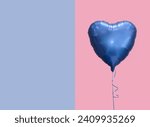 Blue heart balloon against pink color background 