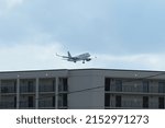 Small photo of Spirit Airlines Airbus Passenger Jet with Old Logo Flying Low Altitude Over Hotel Roof Approaching Myrtle Beach International Airport in Myrtle Beach S.C. USA On September 18, 2017.
