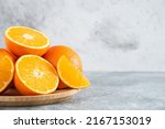Small photo of front view fresh sliced orange on stone background ripe mellow fruit juice color citrus tree citrus, Whole and sliced ripe oranges placed on marble background, half orange fruit.