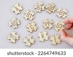 Small photo of Set of puzzles with 13 essential vitamins with inscriptions on a beige background. Complex A, B1-B12, C, D3, E, K, P, PP.