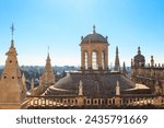 Small photo of View from the Giralda Tower out over the roof and spires of the Seville cathedral with the city in view in Seville, Spain