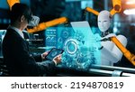 Small photo of Cybernated industry robot and human worker working together in future factory . Concept of artificial intelligence for industrial revolution and automation manufacturing process .
