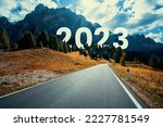 Small photo of 2023 New Year road trip travel and future vision concept . Nature landscape with highway road leading forward to happy new year celebration in the beginning of 2023 for fresh and successful start .