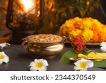 Small photo of Temple Payasam Ari payasam or sarkara payasam in a golden uruli with flowers on the background, Onam sadhya special food